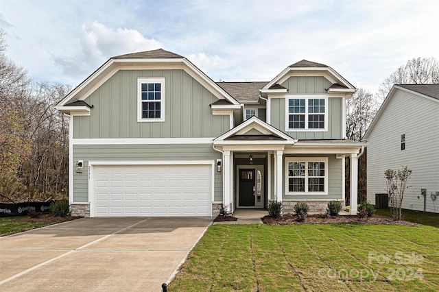 craftsman inspired home featuring a front lawn and a garage