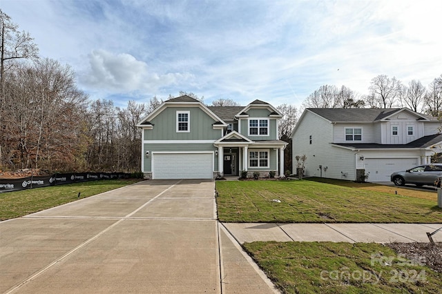 view of front of property with a garage and a front lawn