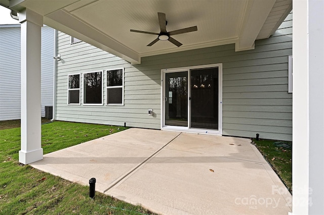 doorway to property featuring ceiling fan, a yard, and a patio