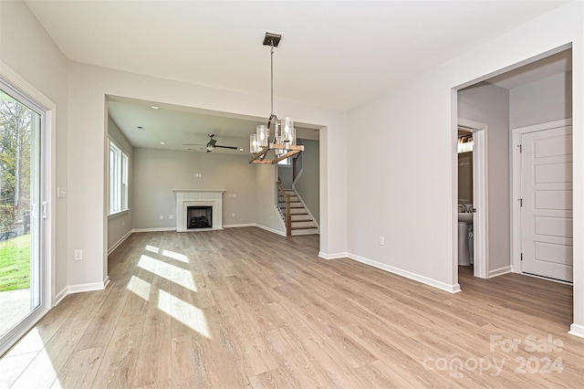 unfurnished living room with light hardwood / wood-style flooring and ceiling fan