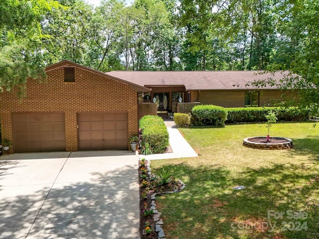 view of front facade with a front yard and a garage