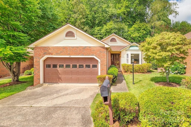 view of front of property featuring a garage and a front yard