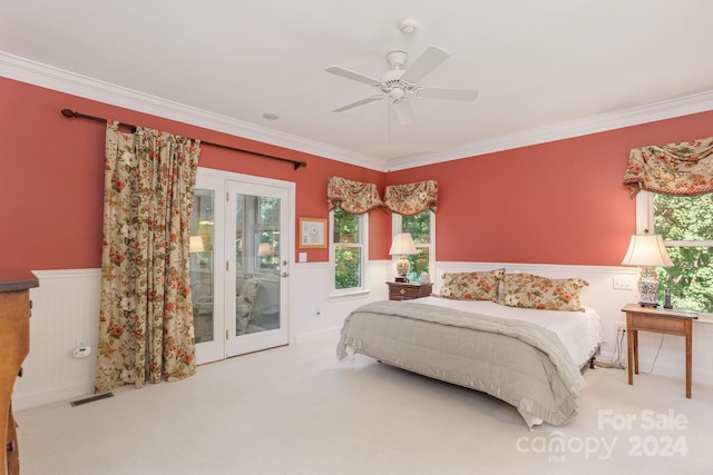 carpeted bedroom featuring access to outside, multiple windows, ceiling fan, and crown molding