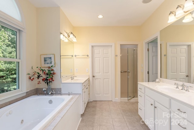 bathroom with tile patterned floors, vanity, and separate shower and tub