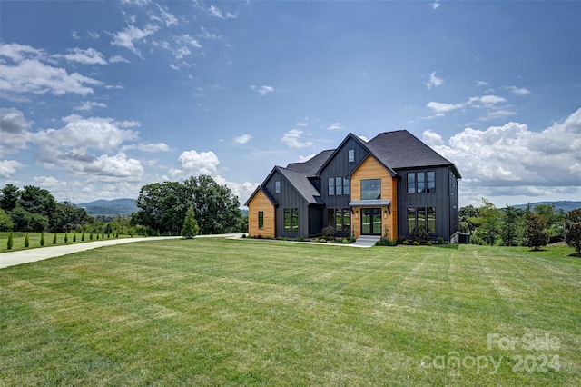 view of front of property with a mountain view and a front yard