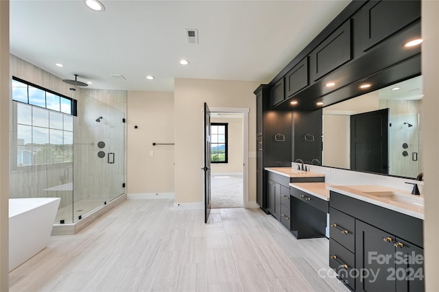 bathroom with independent shower and bath and vanity