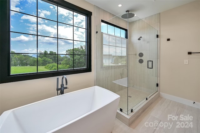 bathroom featuring independent shower and bath