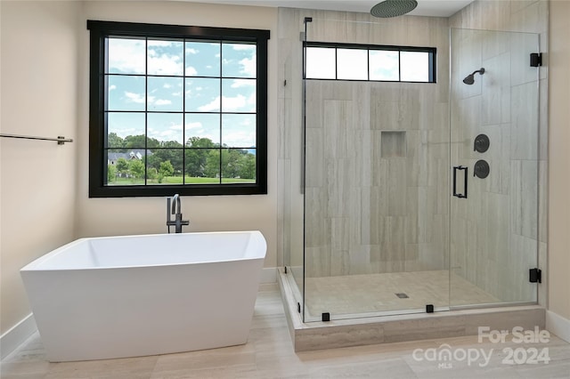 bathroom featuring tile patterned flooring, a wealth of natural light, and shower with separate bathtub