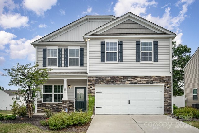 craftsman inspired home featuring a garage and central AC