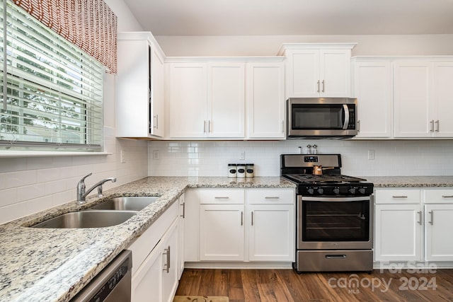 kitchen featuring white cabinets, backsplash, sink, and stainless steel appliances