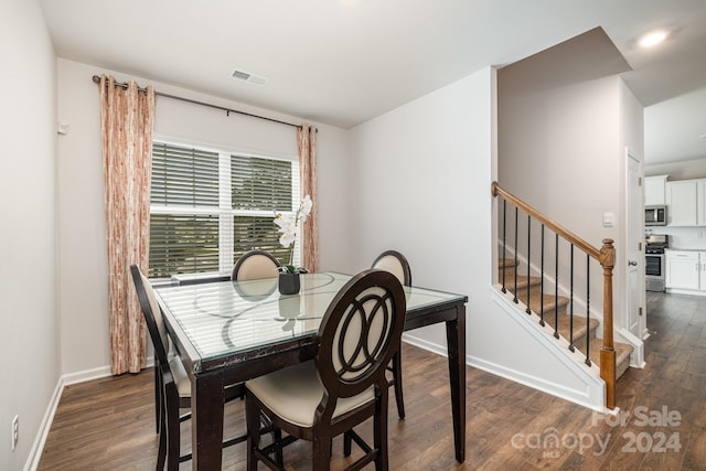 dining area featuring dark wood-type flooring