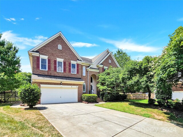 view of front of property with a garage and a front lawn