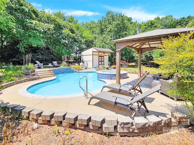 view of swimming pool with an outbuilding, a gazebo, and an in ground hot tub