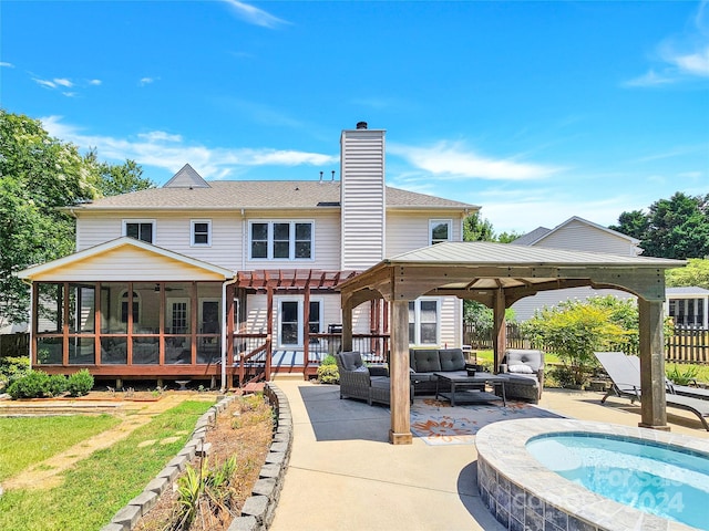 rear view of house featuring a sunroom, a deck, a patio, an outdoor living space, and a pergola