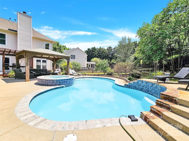 view of pool featuring an in ground hot tub, a patio area, and a gazebo