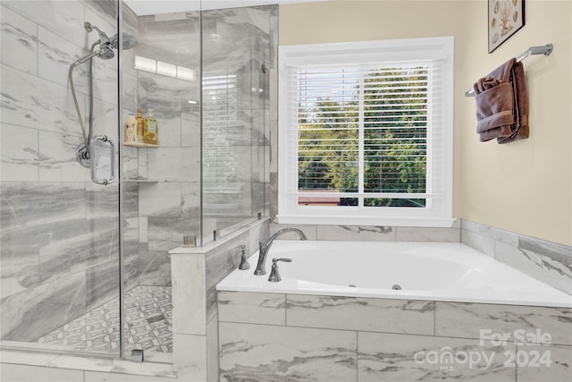 bathroom featuring separate shower and tub