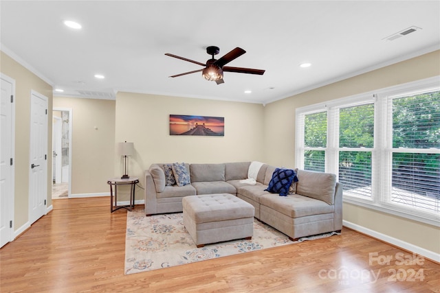 living room with ceiling fan, crown molding, and light hardwood / wood-style flooring