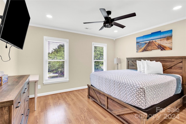 bedroom featuring ceiling fan, crown molding, and light hardwood / wood-style flooring