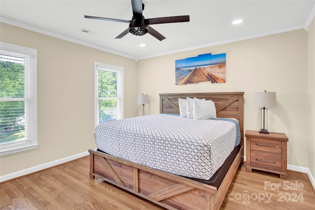 bedroom with light wood-type flooring, ceiling fan, and crown molding