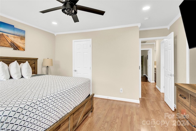 bedroom with ceiling fan, ornamental molding, and light hardwood / wood-style floors