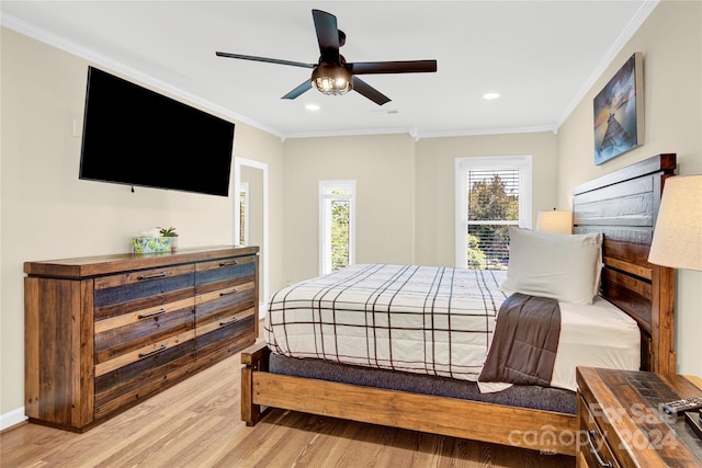 bedroom with ceiling fan, ornamental molding, and light hardwood / wood-style flooring