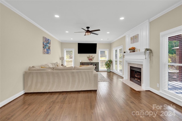 living room with ceiling fan, dark wood-type flooring, and ornamental molding