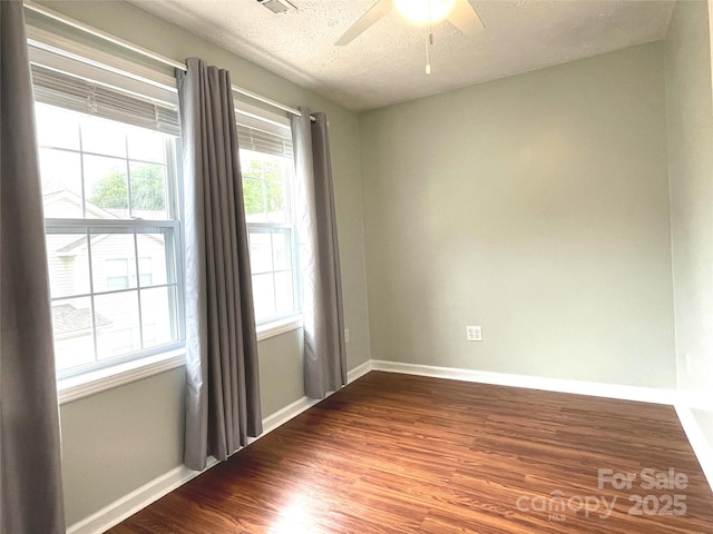 spare room featuring ceiling fan, hardwood / wood-style floors, and a textured ceiling