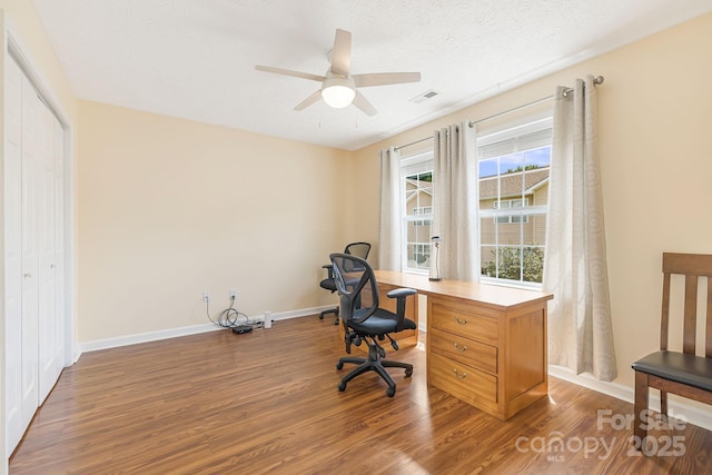 office with ceiling fan, dark hardwood / wood-style floors, and a textured ceiling