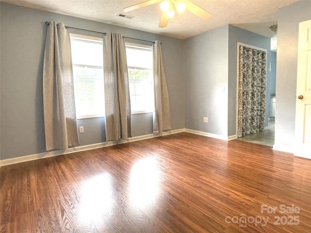 unfurnished room featuring hardwood / wood-style flooring, ceiling fan, and a textured ceiling