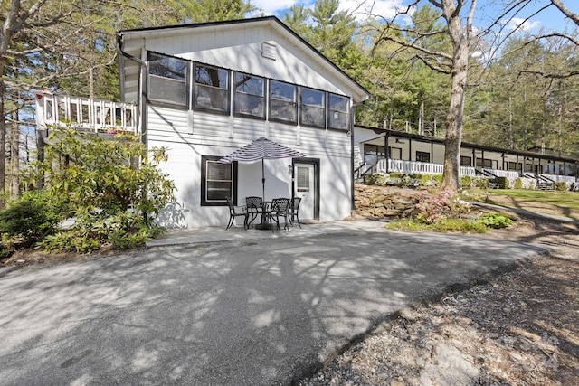 back of property with a patio and a sunroom