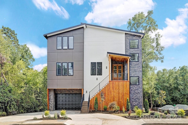 contemporary home featuring french doors and a garage