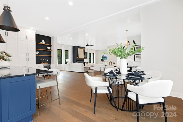 dining room featuring hardwood / wood-style flooring and built in shelves