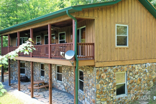 back of property featuring a balcony and a patio area