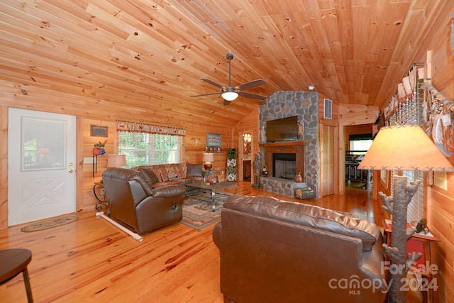 living room featuring lofted ceiling, wood walls, and wood ceiling