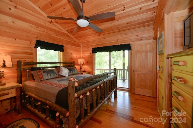 bedroom featuring lofted ceiling, wooden walls, wood ceiling, and light hardwood / wood-style flooring