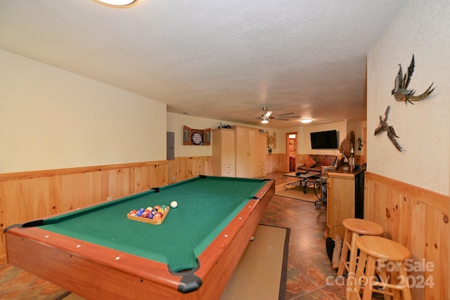 playroom with electric panel, a textured ceiling, ceiling fan, and billiards