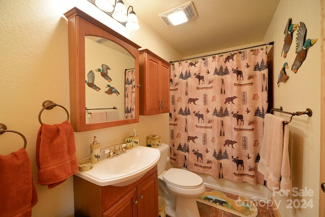 full bathroom with shower / tub combo, tile patterned flooring, vanity, and toilet