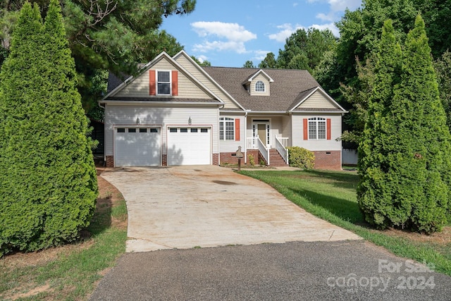 view of front facade with a garage and a front lawn