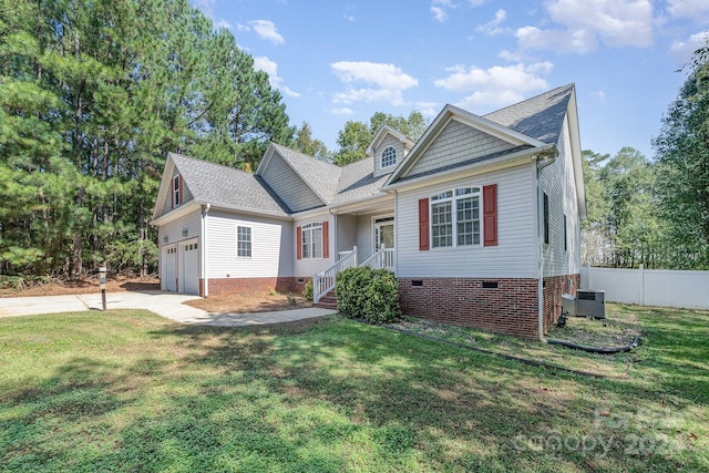 view of front of property featuring central air condition unit, a garage, and a front lawn