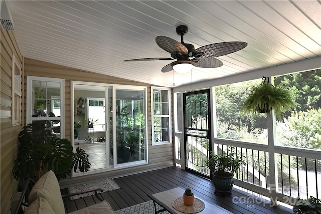 sunroom / solarium featuring lofted ceiling, ceiling fan, and a wealth of natural light