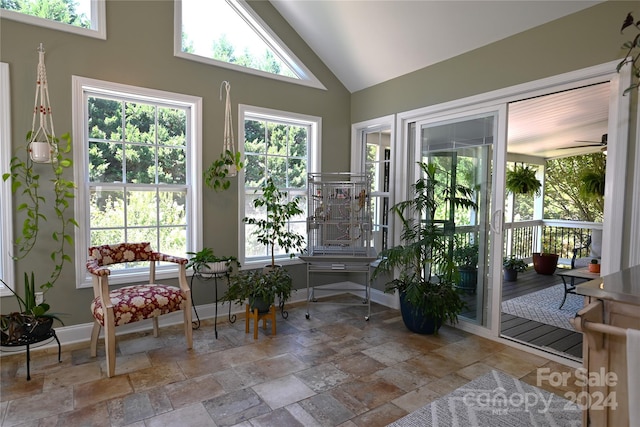 sunroom / solarium featuring vaulted ceiling