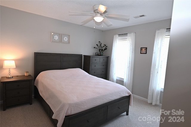 bedroom with ceiling fan and light colored carpet