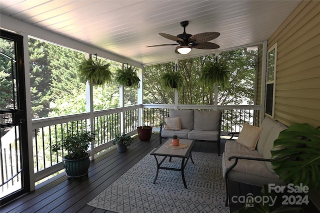 wooden deck with ceiling fan and an outdoor hangout area