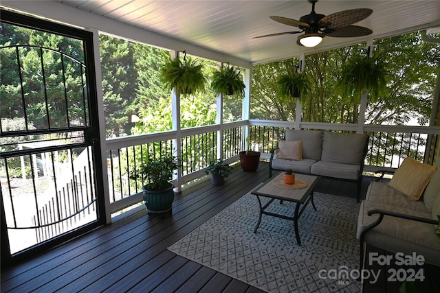 wooden deck with ceiling fan and outdoor lounge area