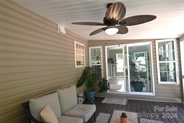 sunroom featuring ceiling fan and lofted ceiling