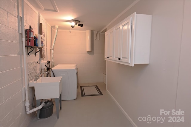 laundry room with washer and dryer and cabinets