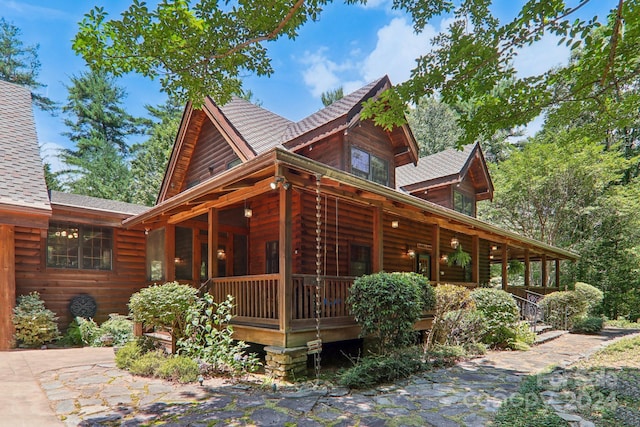 view of property exterior featuring covered porch