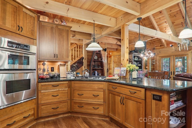 kitchen featuring decorative light fixtures, beamed ceiling, and stainless steel appliances