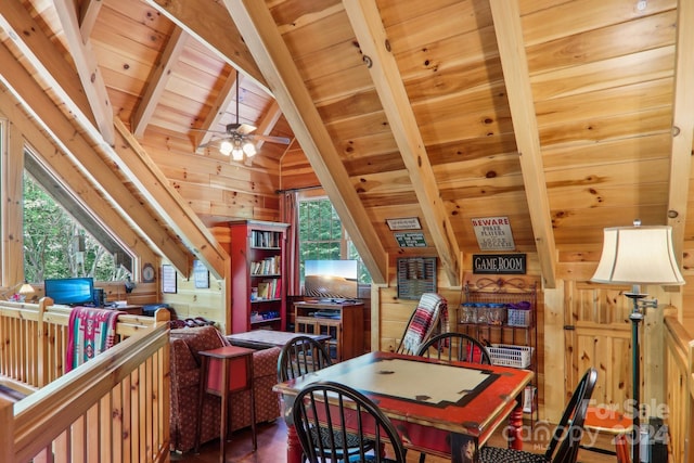 dining area featuring plenty of natural light, wooden ceiling, wood walls, and vaulted ceiling with beams