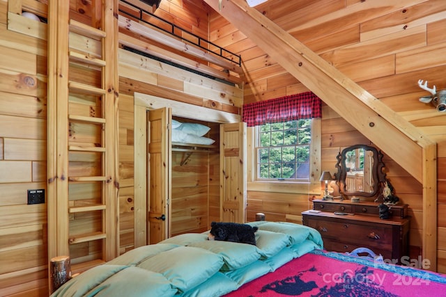 bedroom featuring wooden ceiling, lofted ceiling, and wooden walls